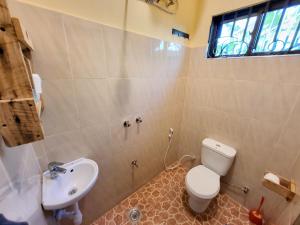 a bathroom with a toilet and a sink at Jangwani Riverview Suits in Mto wa Mbu +27 photos
