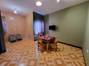 a dining room with a wooden table and chairs at Jangwani Riverview Suits in Mto wa Mbu