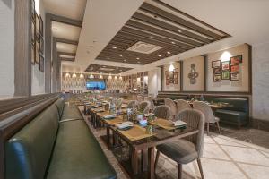 a dining room with wooden tables and chairs at BluSalzz Residence Amritsar in Amritsar