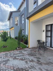 a patio with a table next to a building at KLAAK hotel and Apartments in Ga-Masamothane