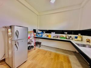 a kitchen with a refrigerator and a counter at In Dream Villa in Rekawa