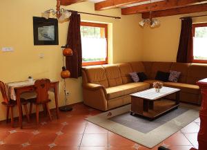 a living room with a couch and a table at Chata Dominika - Tále in Bystrá