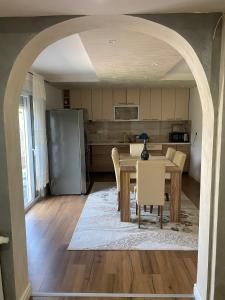 a kitchen and dining room with a table and chairs at Murat villa in SJJ