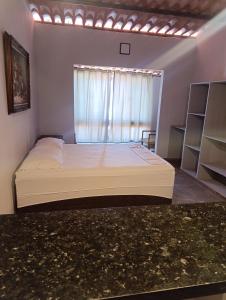 En eller flere senge i et værelse på Divas do mar kitnet 7 + 8 billeder