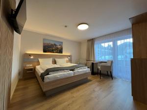 a bedroom with a bed and a desk and a table at Haus Luise in Bad Hindelang +20 photos