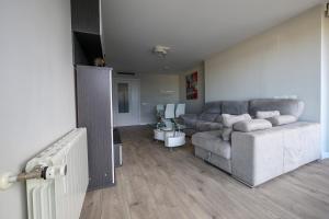 a living room with a couch and a table at Apartamento Cervantino in Alcalá de Henares +69 photos