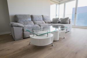 a living room with a couch and a glass table at Apartamento Cervantino in Alcalá de Henares