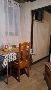 a wooden chair sitting at a table in a room at Departamento interior, con estacionamiento in Panguipulli