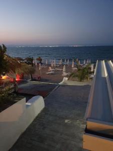 a view of a beach with umbrellas and the ocean at Dom Lidiya in Pomorie
