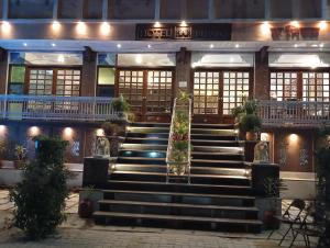 a building with stairs and plants in front of it at Hotel Har Niwas udaipur city of lakes in Udaipur
