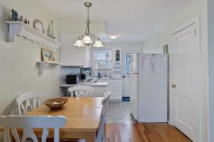 a kitchen with a wooden table and a white refrigerator at 308A E Heather Rd, #3081 in Wildwood Crest +8 photos