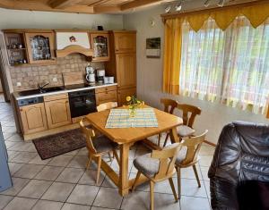 a kitchen with a table and chairs in a room at Hauser Hof Grübl in Waldkirchen