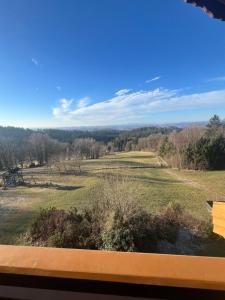 a view from a window of a golf course at Hauser Hof Grübl in Waldkirchen