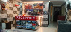 a reception area in a building with a red sign at Hotel Gloria Rishikesh in Rishīkesh