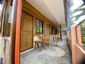 a row of tables and chairs in a room at The Tribe Apartment in Port Barton