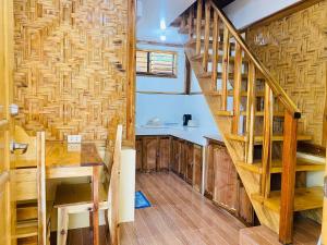 a kitchen with a wooden staircase in a house at The Tribe Apartment in Port Barton +20 photos