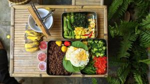 two trays of food on a wooden tray at Homestay Dat Phu in Tuy Hoa