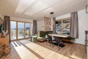 a living room with a table and chairs and a couch at my Zillernest in Zell am Ziller
