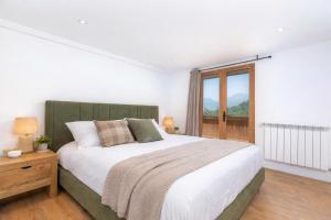 En eller flere senge i et værelse på Appartements dans le Chalet Nessa - Combloux