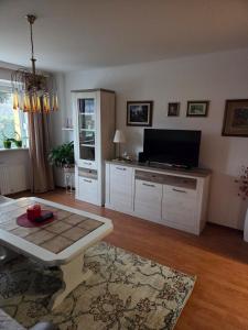 a living room with a tv and a table at Apartment SOFI Novi Travnik in Novi Travnik
