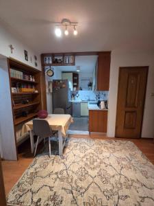 a living room with a table and a kitchen at Apartment SOFI Novi Travnik in Novi Travnik