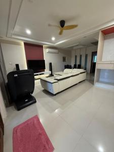 a living room with a bed and a ceiling fan at The Luxe Stay in Kuching +14 photos