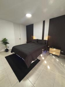 a bedroom with a large bed and a potted plant at Son de Metro Apartment - Condado Beach & Pool, Walk to Ocean in San Juan +15 photos