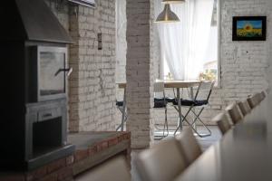 a living room with a fireplace and a table and chairs at Hostal Agrobotiga 7 de Ribera in Móra d'Ebre