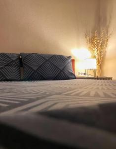 a bedroom with a bed with a pillow and a lamp at Μικρό διαμέρισμα 20μ από την κεντρική πλατεία in Kalamata