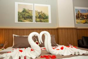 two white swans are sitting on top of a bed at Airport Corner Hotel in Trabzon +37 photos