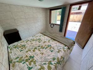 a bedroom with a bed in a small room at Casa do Cerrado in Santana do Riacho +14 photos