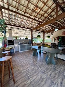 a large living room with a table and a stove at Casa do Cerrado in Santana do Riacho