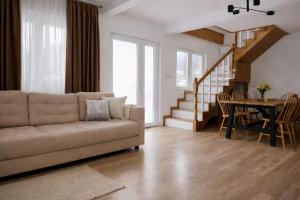 a living room with a couch and a table at Liziera Cabin Malaia in Malaia