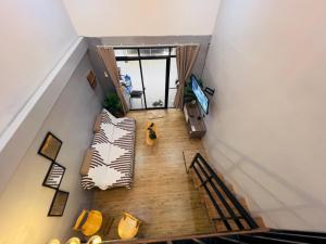an overhead view of a living room with couches at Homey Hideout- Athena and Noah Units in Magalang