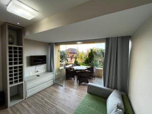 a living room with a couch and a sliding glass door at Gravatá WinterVille Flat 913 in Gravatá