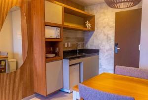 eine Küche mit Spüle und Tisch in einem Zimmer in der Unterkunft Casa de Praia Atalaia in Salinópolis