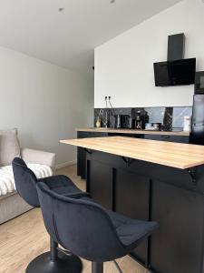 a kitchen with a table and two chairs in a room at Solar Dream - close to Disney in Lagny
