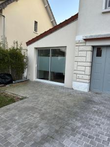 a driveway in front of a house with a garage at Solar Dream - close to Disney in Lagny