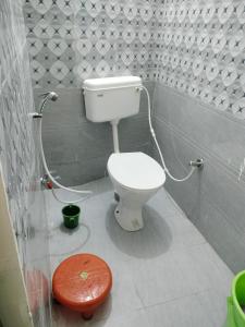 a bathroom with a white toilet in a room at Hotel Krishn Residency in Garwa Road