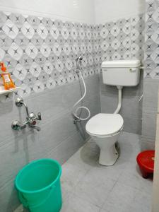 a bathroom with a toilet and a shower in it at Hotel Krishn Residency in Garwa Road
