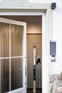 a door to a house with a snowboard on it at Alpstay - Chalet Hotel Hartmann - Adults Only in Ortisei