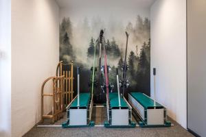 a room with a wall with a painting of trees at Alpstay - Chalet Hotel Hartmann - Adults Only in Ortisei