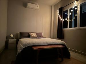 a bedroom with a bed and a window with lights at Cozy Relax & Calm in Koh Phangan