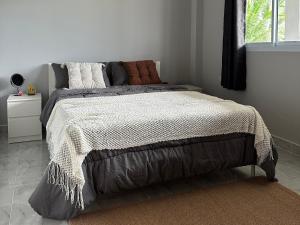 a bedroom with a large bed in a white room at Cozy Relax & Calm in Koh Phangan