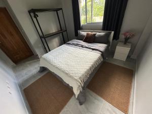 a small bed in a small room with a window at Cozy Relax & Calm in Koh Phangan