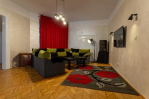 a living room with a couch and a red curtain at Casa Balcescu in Braşov