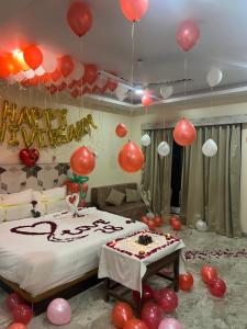 une chambre avec des ballons et un lit avec un gâteau dans l'établissement Sabas Tent & Cottages, à Mahabaleshwar 32 autres photos