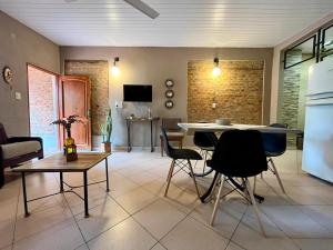 a living room with a table and chairs and a kitchen at Casa Tekove in Clorinda