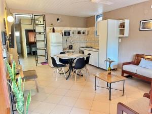 a living room and kitchen with a couch and a table at Casa Tekove in Clorinda +12 photos