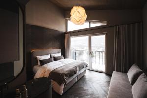 En eller flere senge i et værelse på Alpine Boutique Hotel wollée